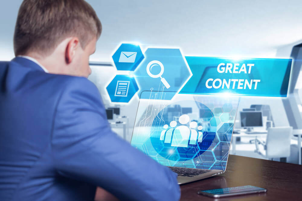 Business, technology, internet and networking concept. Young businessman working on his laptop in the office, select the icon great content on the virtual display.