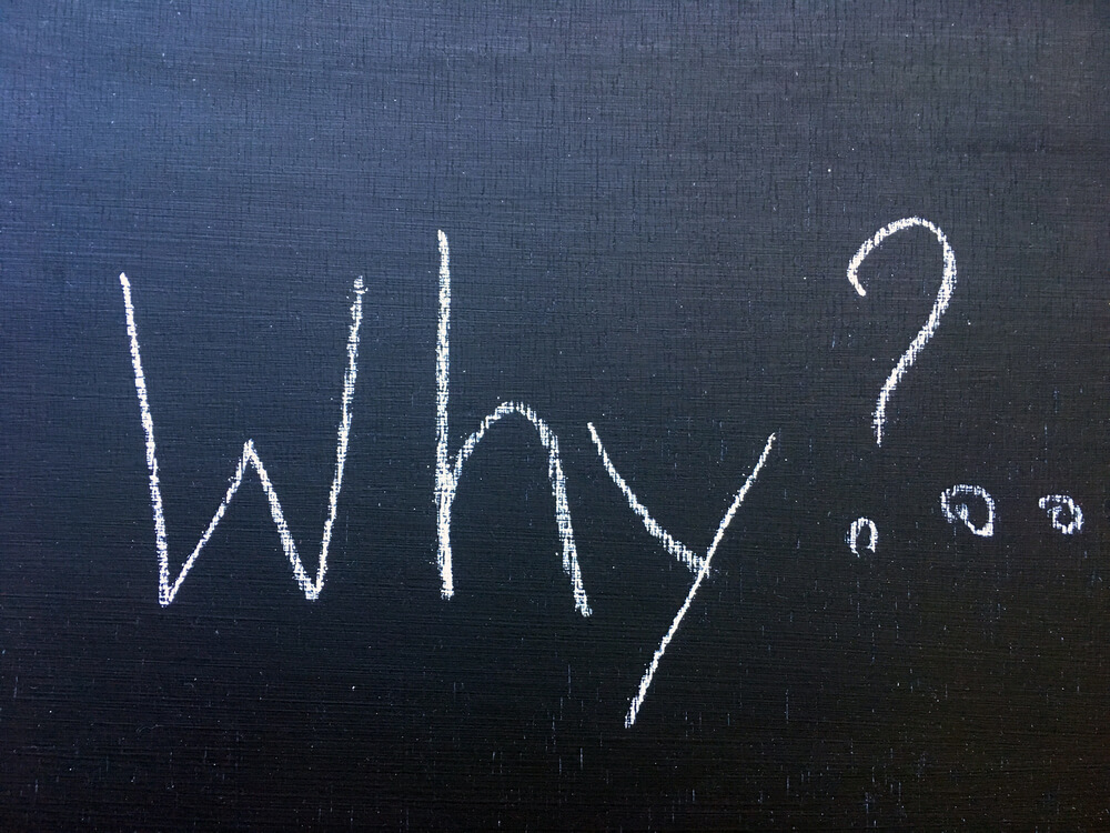 the word 'why?' written on a chalboard