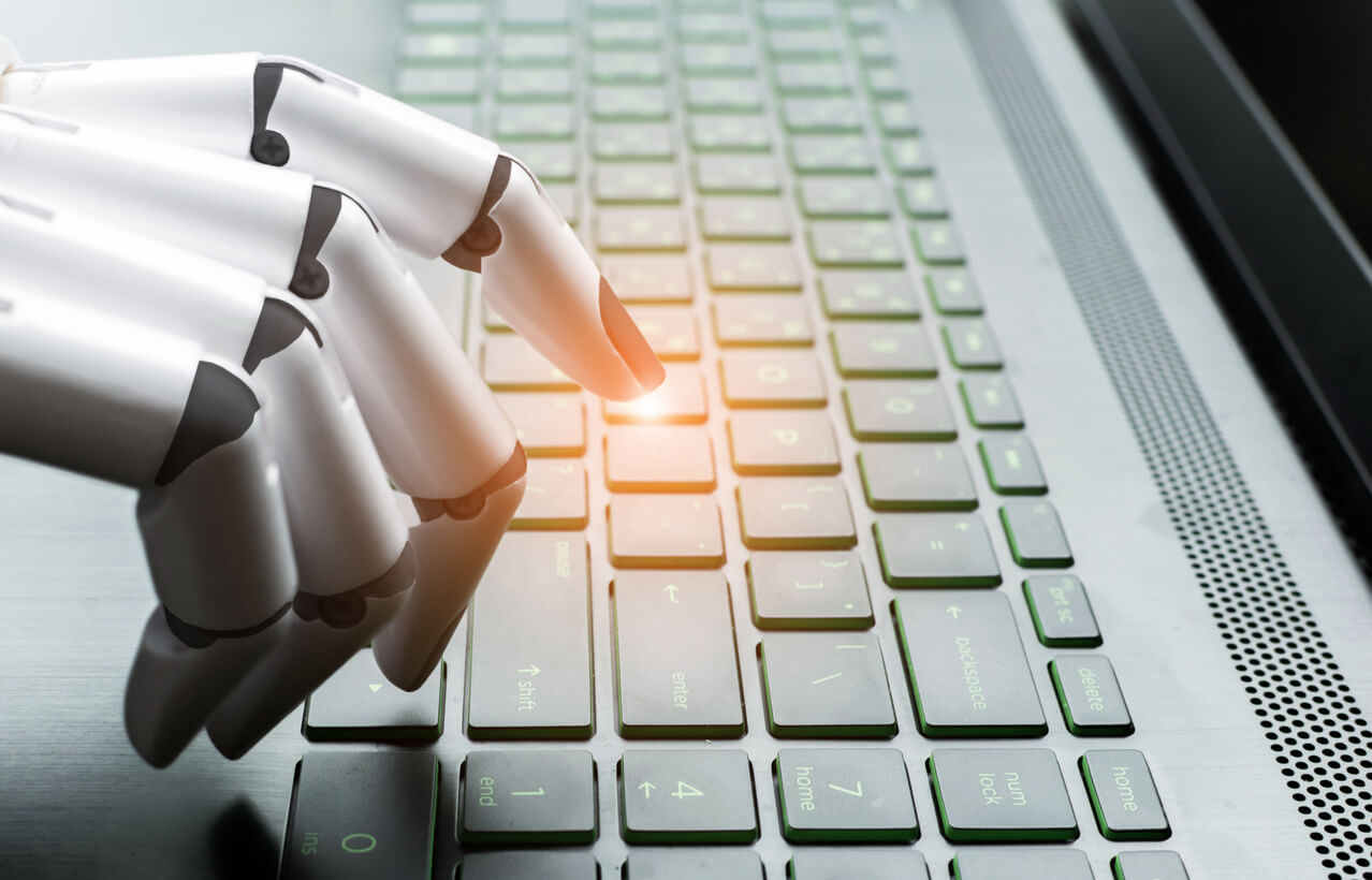 Robot hand touching keys on a keyboard